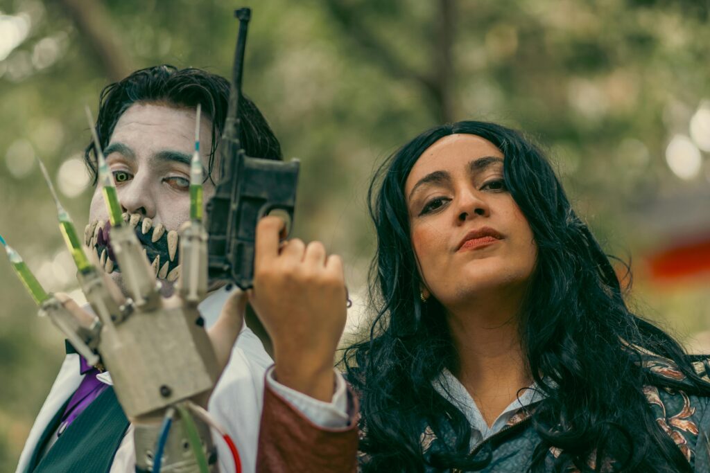 Two cosplayers in vibrant costumes during a themed event in Mexico City.