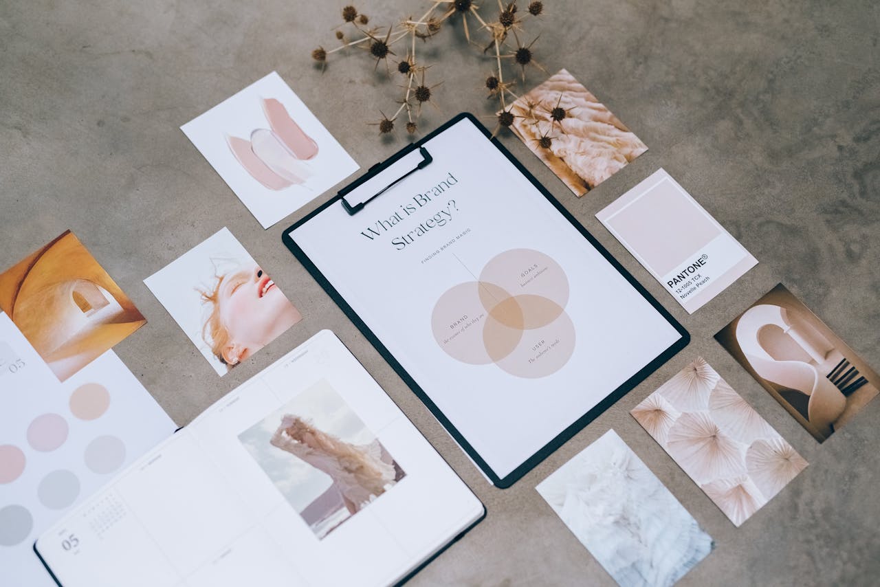 Flat lay of a minimalist brand strategy moodboard on a concrete surface.